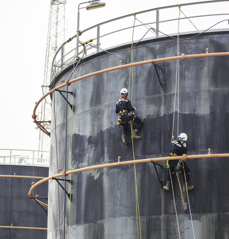 Male two worker down height tank roof rope access safety inspection of thickness storage tank crude oil